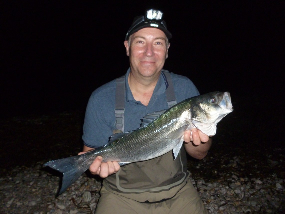 Big bass caught on a lure in darkness
